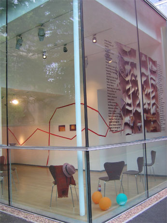 corner view through glass windows into gallery, with image transfered onto glass 